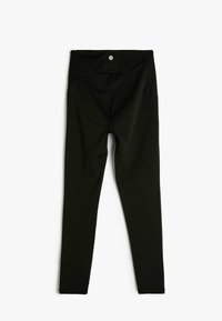 Leggings negros hechos de una tela elástica con una cintura alta. Diseño simple sin patrones visibles ni herrajes. Textura suave.