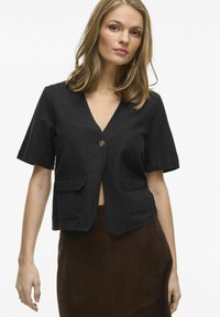 Svart kortärmad jacka med v-ringning, en knappstängning och två framfickor; tillverkad av ett strukturerat tyg. Avslappnad passform.