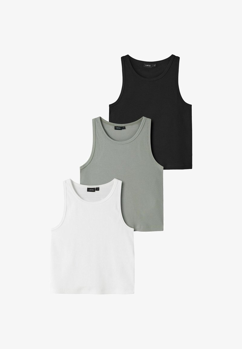 Trois débardeurs côtelés sans manches en noir, gris et blanc, disposés en chevauchement sur un fond blanc.