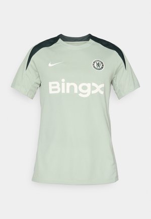 Heled roheline Nike jalgpallijersey mustade aktsentidega, lühikeste varrukatega, ümar kaelus, millel on rindkeres "Bingx" logo ja Chelsea FC märk.