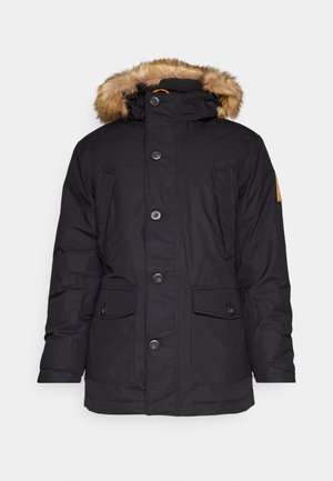 Parka negra aislante con borde de capucha de piel sintética, cinco bolsillos frontales y cierre de botones. Tejido suave con un acabado ligeramente mate.
