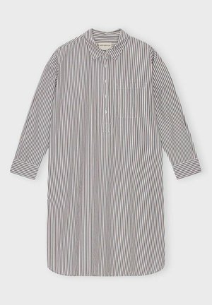 Striped long-sleeve shirt in white and dark blue, featuring a button front, collar, and left chest pocket. Soft cotton material.