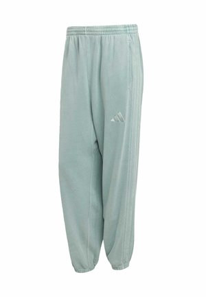 Pantaloni jogger verde chiaro realizzati in tessuto morbido, dotati di vita elasticizzata, tasche laterali e un piccolo logo in rilievo sulla coscia.