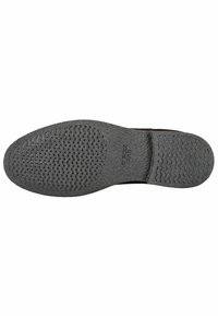 Suola di scarpa in gomma nera con motivi di grip testurizzati; presenta piccoli fori di ventilazione e una leggera curvatura nella punta. Logo del marchio visibile.
