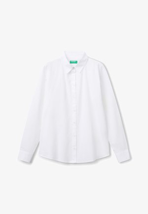 Witte katoenen blouse met lange mouwen. Voorzien van een klassieke kraag, knoopsluiting aan de voorkant en knoopmanchetten.