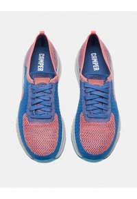Blue and pink knitted sneakers with a textured upper, round toe, and flat laces. Features a blue logo on the tongue and a gray sole.