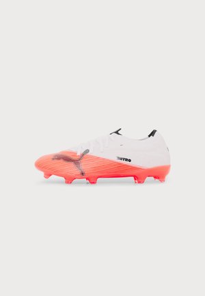 Weißer und leuchtend korallenfarbener Fußballschuh mit schwarzem Puma-Logo und Text "Nitro", mit geformten Stollen und Schnürverschluss.