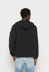 Tommy Jeans CHICAGO UNISEX - Vetrovka - black