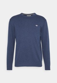 Marineblauer langärmliger Rundhalsausschnitt-Pullover aus weichem Material, mit einem kleinen Logo auf der Brust sowie gerippten Bündchen und Saum.