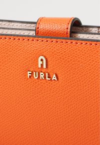 Oranje gestructureerde lederen portemonnee met gouden "FURLA" logo. Voorzien van een soepele sluiting en gestikte accenten, die een levendige kleur en verfijnd ontwerp benadrukken.