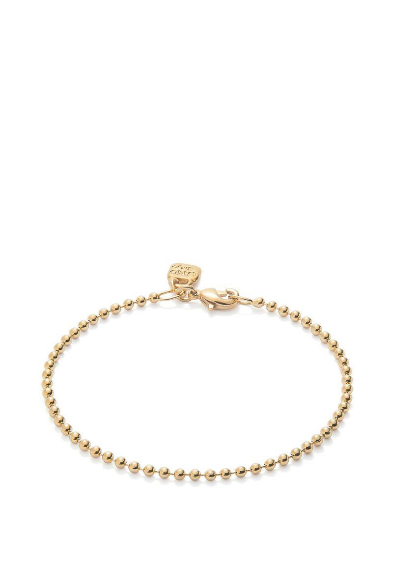 Pulsera de oro con un diseño de cuentas, con un cierre de langosta y una pequeña etiqueta adjunta. Acabado dorado liso en toda la superficie.