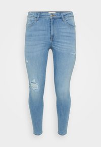 Light blue denim skinny jeans featuring a mid-rise waist, ripped detailing on the thighs, and a classic five-pocket design.