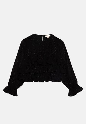 Blouse noire à manches longues avec petits pois argentés, détails à volants superposés sur le devant et aux poignets, et fermeture au dos avec bouton et ouverture en forme de clé.