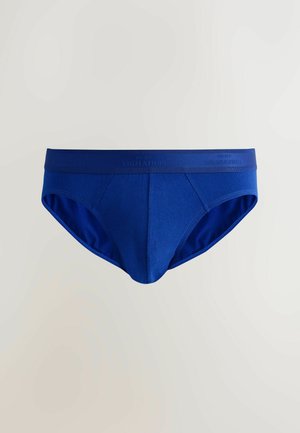 Blå herrkalsonger av mjukt tyg, med ett brett elastiskt midjeband märkt "NEXT SIGNATURE" och en klassisk modell utan mönster.