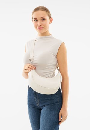 White leather hobo bag with curved design and adjustable strap, featuring silver hardware and a smooth texture. Simple and modern shape.