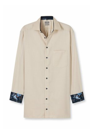 Helle beige Langarmbluse mit schwarzen Knöpfen, einer Brusttasche und floral gemusterten blauen Manschetten. Glatte Textur und klassisches Kragendesign.