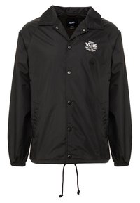 Giacca nera in nylon con colletto, chiusura a bottoni automatici, polsini elasticizzati e orlo con coulisse. Presenta il logo "VANS" in bianco.
