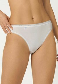 White cotton briefs with a smooth texture, featuring a delicate lace trim along the waistband and leg openings. Logo tag is visible.