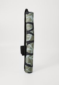 Cylindrical yoga mat bag with a camo pattern in green and black, made of textured fabric, featuring a black strap and velcro closure.