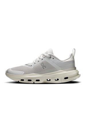 Light gray athletic shoe with mesh upper, cushioned sole featuring hexagonal cutouts, lace-up closure, and pull tab at heel.