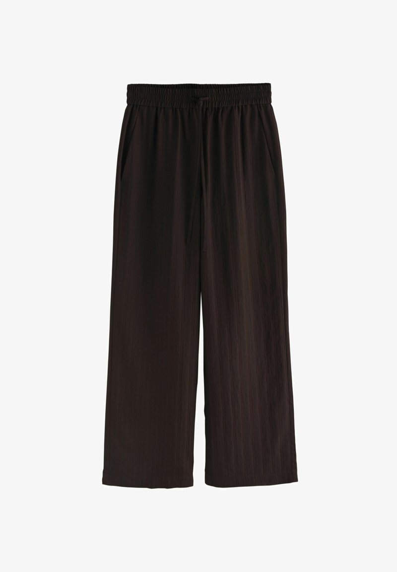 Pantalon large noir avec taille élastique et poches latérales, confectionné dans un tissu léger légèrement texturé.