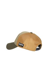 Gorra con cuerpo de malla color beige y visera verde oliva. Presenta una etiqueta negra con texto blanco. Cierre trasero ajustable, forma redondeada.