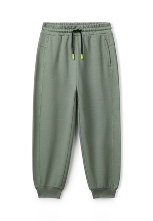Helle grüne Jogginghosen mit elastischem Bund, schwarzem Kordelzug mit neonfarbenen Enden, seitlichen Taschen und gerippten Bündchen.