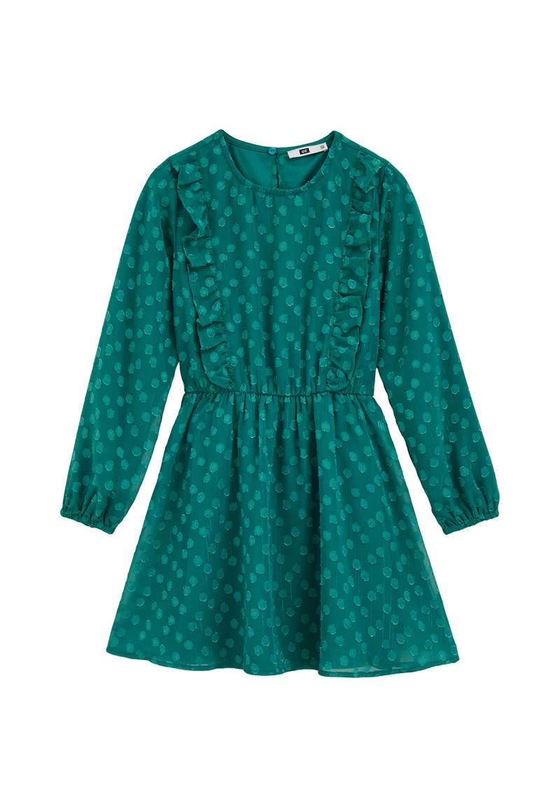 Zelena haljina s dugim rukavima, okruglim izrezom, naboranim prednjim dijelom i strukom zdjelice. Ima točkasti uzorak i suknju koja se širi.