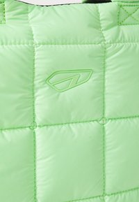 Padded bag in bright green material with quilted design. Features embossed logo and contrasting black strap. Soft, smooth texture.