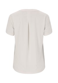 Camisa de manga corta de color beige claro, con un pliegue central en la parte trasera y dobladillo redondeado, mostrada desde atrás sobre un fondo blanco.