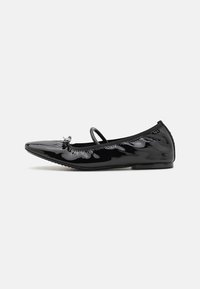 Black patent leather ballet flat with a pointed toe, elastic strap, and decorative bow accent. Smooth finish with minimal stitching detail.