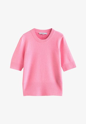 Rosa kortärmad tröja med rund halsringning. Gjord av mjukt material, med ribbade muddar och fåll. Enkel, boxig design.