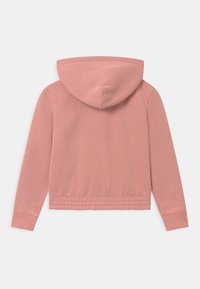 Felpa con cappuccio rosa, dal texture morbido, con polsini a coste e cappuccio regolabile con cordino. Presenta una vestibilità ampia e un orlo elastico.