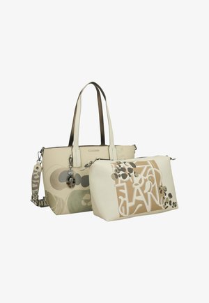 Beige Tragetasche mit abstrakten kreisförmigen Mustern und passendem kleineren Beutel mit braunem und cremefarbenem Graffiti-Design, beide mit Schultergurten.