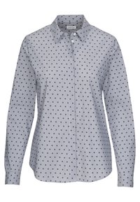 Chemise à manches longues boutonnée avec une base blanche et de petits pois noirs, dotée d'un col pointu et de poignets ajustés.