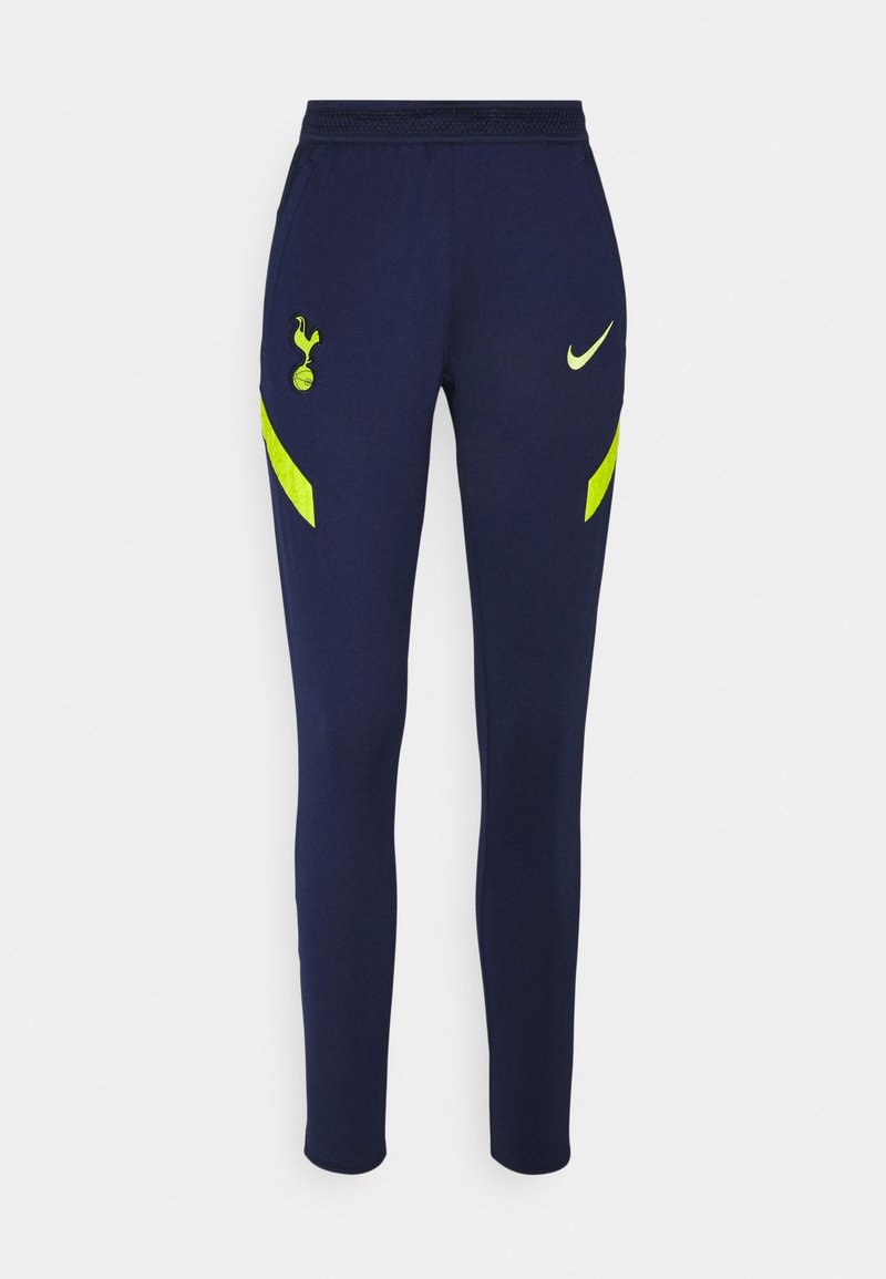 Pantalones de chándal en color navy, confeccionados con material flexible y con un diseño ajustado. Incluyen franjas de acento en amarillo y logotipos en el muslo izquierdo y en la cintura.