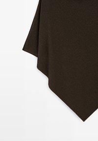 Dark brown textured fabric with a soft, draped edge hanging against a light background.