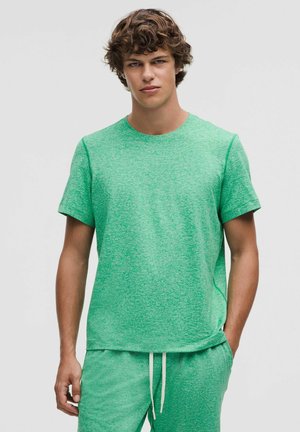 Green short-sleeve T-shirt with a textured, heathered pattern. Crew neck design, relaxed fit, and subtle side seam detailing.