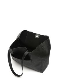 Black tote bag made of textured synthetic leather, featuring an open top, long handles, and a magnetic snap closure. Interior is unlined.