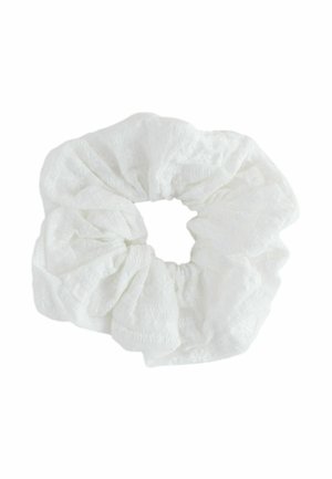 White fabric scrunchie with subtle embroidered floral patterns, gathered in a circular shape for hair styling.