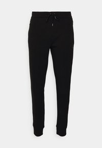 Svarta träningsbyxor med dragsko i midjan, smalnande ben och sidodragkedjor. Tillverkade av mjukt tyg med en slät yta.