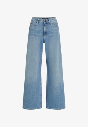 Jean large bleu clair en denim, avec une taille haute, un design à cinq poches et un léger dégradé sur le tissu.