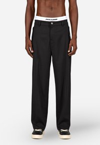 Melni plati bikses ar pogu aizdari, sānu kabatām un baltu logotipa jostu ar uzrakstu "PEGADOR". Strukturēta auduma, brīvs piegriezums.