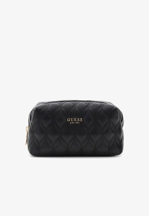Pochette Guess matelassée noire avec fermeture éclair dorée et logo "GUESS EST 1981" en lettres dorées sur le devant, présentée sur fond blanc.