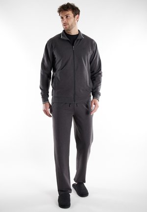 Gray zip-up jacket with contrasting white collar, matching gray pants, and dark slippers. Smooth fabric texture, relaxed fit, minimal detailing.