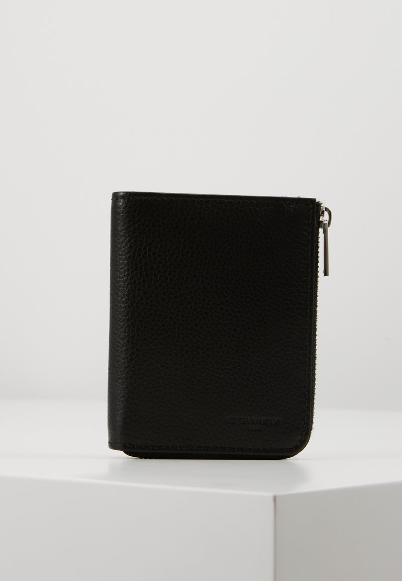 Black leather wallet with a textured finish, featuring a zip closure and minimal branding. Compact rectangular shape, simple design.