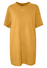 Musztardowożółta, oversize koszulka z bawełny z okrągłym dekoltem. Na środku przedniej części biały logo Nike. Krótkie rękawy.