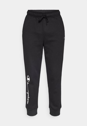 Pantaloni della tuta neri con vita elastica e coulisse. Gambe affusolate con orli elasticizzati. Logo bianco "Champion" sulla gamba sinistra. Tessuto morbido.