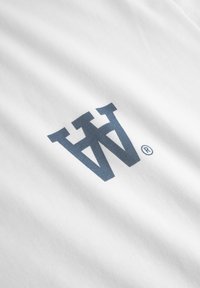White fabric t-shirt featuring a large dark blue graphic logo with a registered trademark symbol. The texture appears smooth and soft.