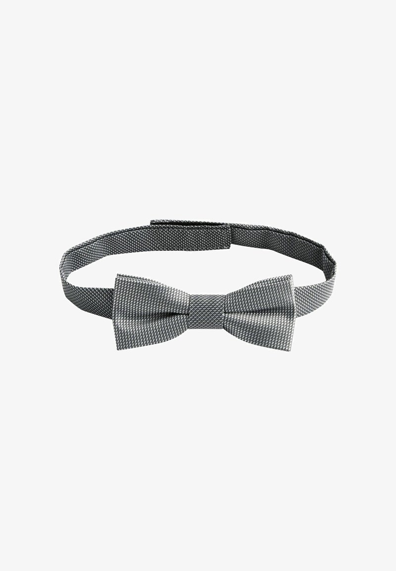 Nœud papillon en tissu noir et blanc à motifs avec sangle réglable, posé à plat sur fond blanc.